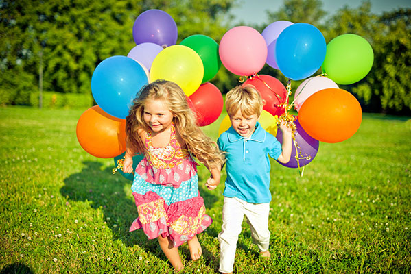 Children running with balloons